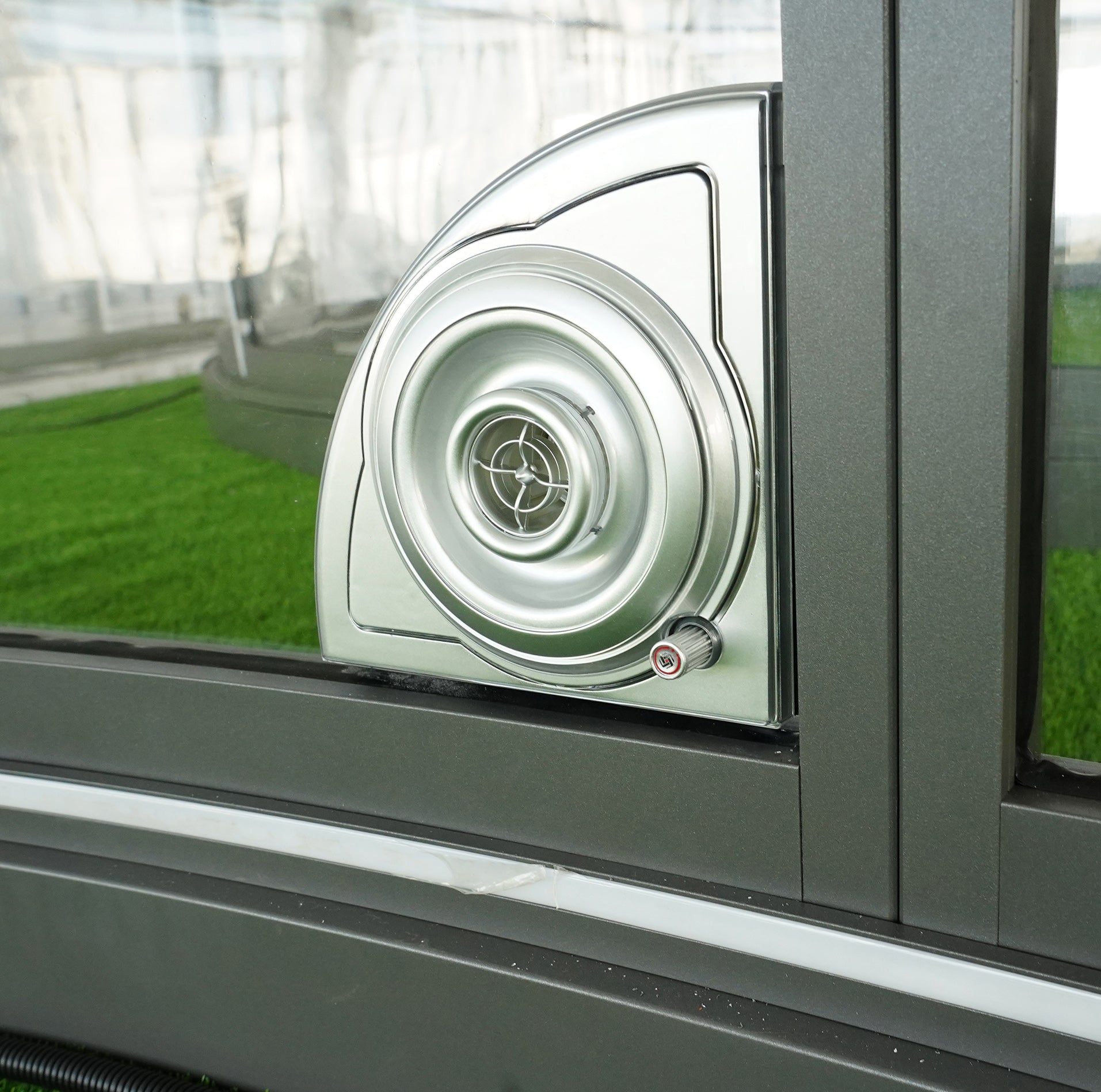 Alt text: "Close-up of a porthole window on a geodesic dome, showcasing the sleek design and high-quality materials used in luxury glamping solutions. Ideal for creating a stylish and sustainable outdoor dome or backyard office."